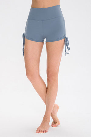 Light blue ruched-side active shorts with drawstrings and a high waist.