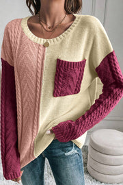 Colorblock cable knit sweater with crew neck and chest pocket in red-violet and cream acrylic.