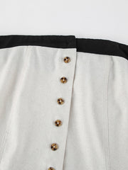 Button front tube maxi dress in beige cotton blend with tortoiseshell buttons and black trim.