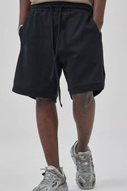 Black textured drawstring boxer shorts with pockets.
