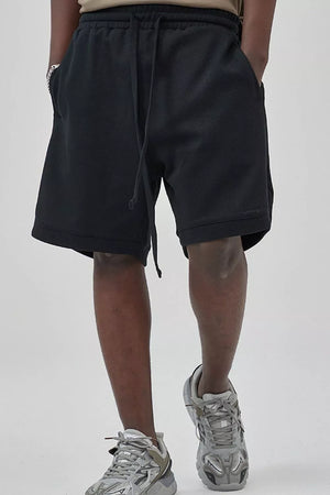 Black textured drawstring boxer shorts with pockets.