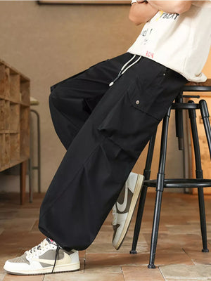 Black cargo pants with drawstring waist and button-flap pockets