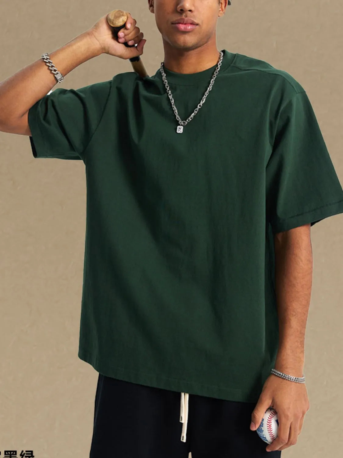 Dark green boxy cut t-shirt with a crew neck and short sleeves.