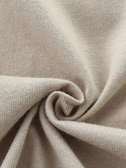 Close-up of beige cotton knit fabric with soft texture.