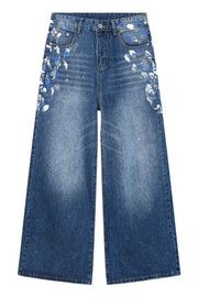 Painterly denim palazzo trousers in medium wash with artistic blue and white paint splatters.