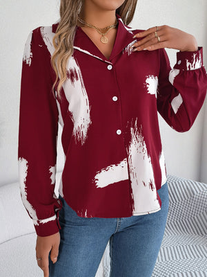 Burgundy brushstroke print collared blouse with white buttons and long sleeves.
