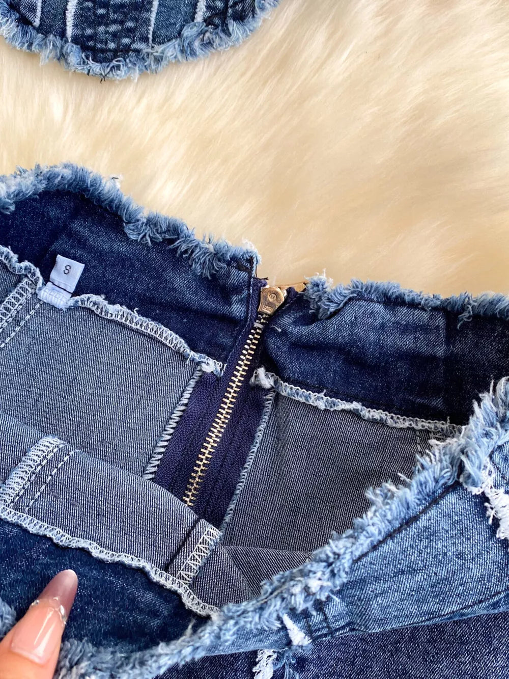 Denim cami and flare set with raw hem detail and zipper closure.