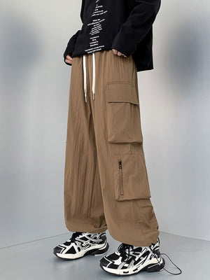 Men's camel cargo sweatpants with drawstring and multiple pockets.
