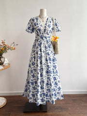 Delightful Floral V-neck Maxi Dress with knotted waist detail and short puff sleeves.