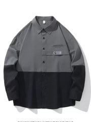 Oversized casual button-down shirt in color-block grey and black with chest pocket detail.