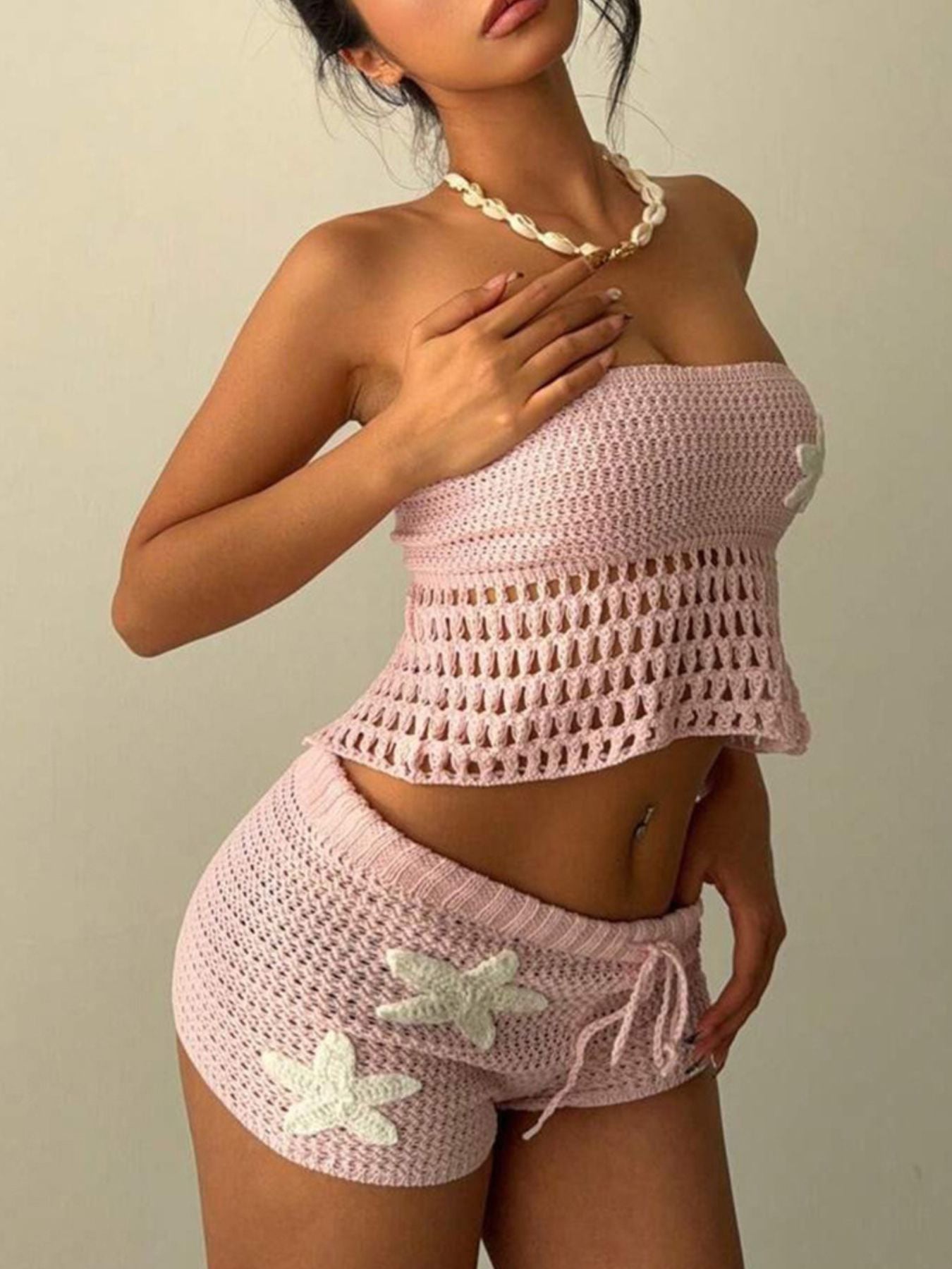 Pink crochet tube top and shorts set with starfish appliques and drawstring shorts.