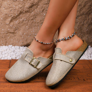 Khaki rhinestone buckle slip-on mules with cork sole detail.