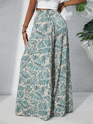 Palazzo trousers in green tropical leaf print, 100% polyester, with a high elastic waist.