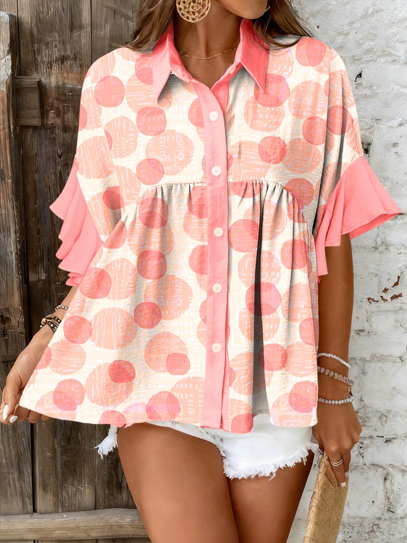 Polka dot babydoll blouse with ruffle sleeves and button front.