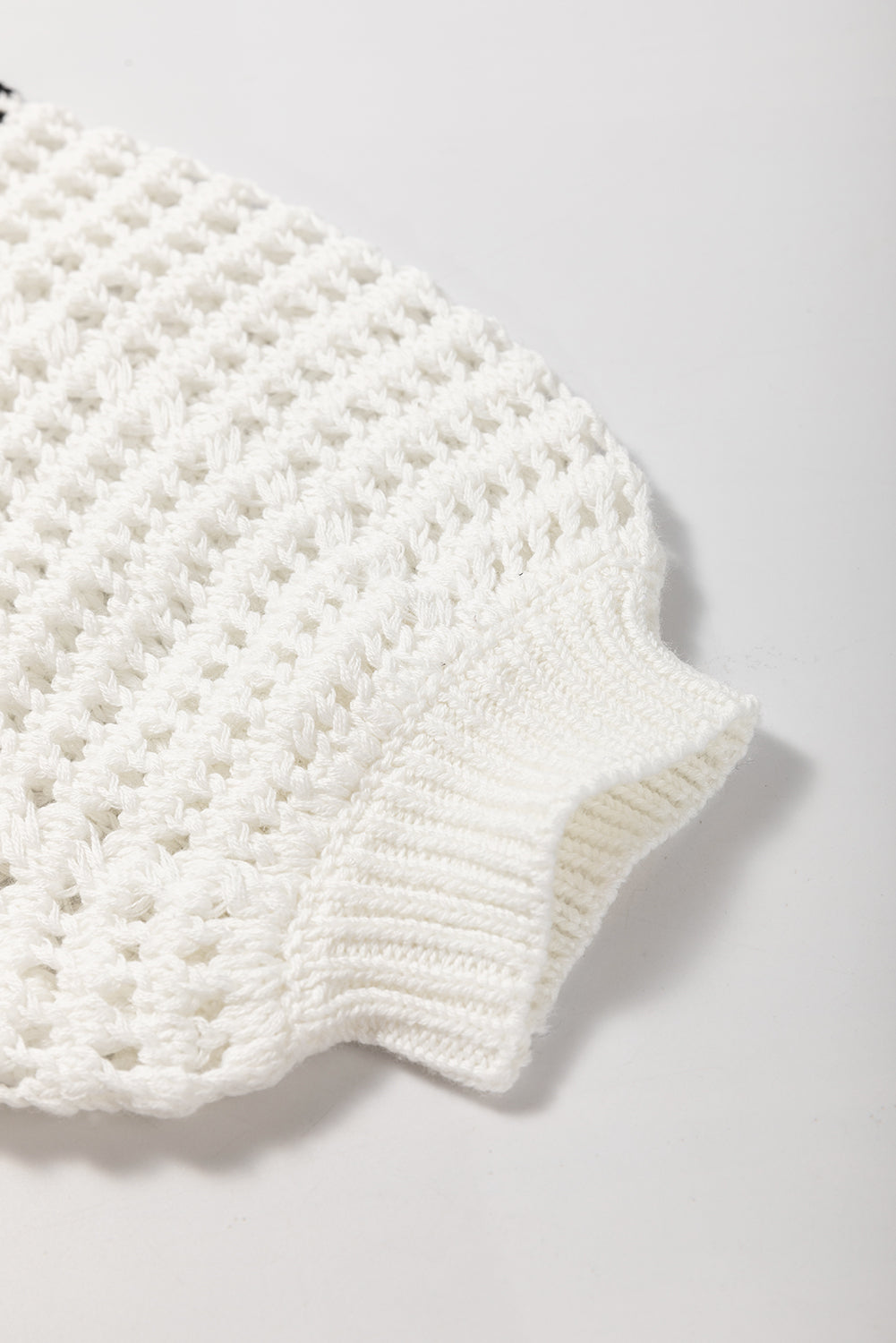White crochet knit pullover sweater with ribbed cuffs and graphic stripe detail.