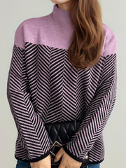 Chevron knit turtleneck sweater in lavender and black with a chevron pattern.