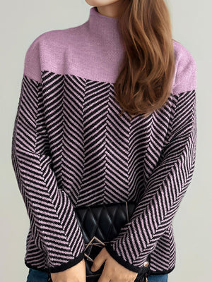 Chevron knit turtleneck sweater in lavender and black with a chevron pattern.