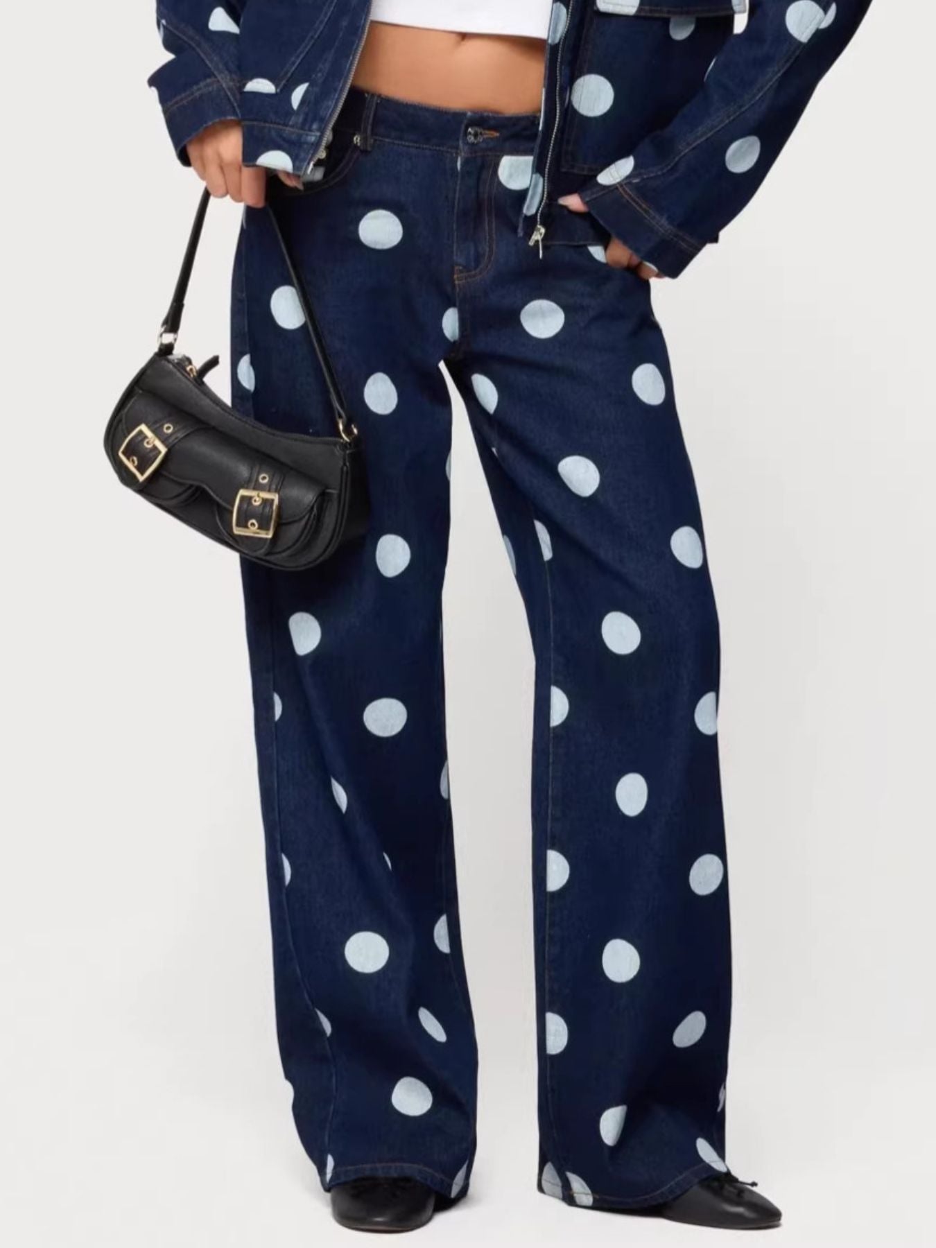 Polka dot wide leg denim maternity jeans in dark blue with white polka dots.