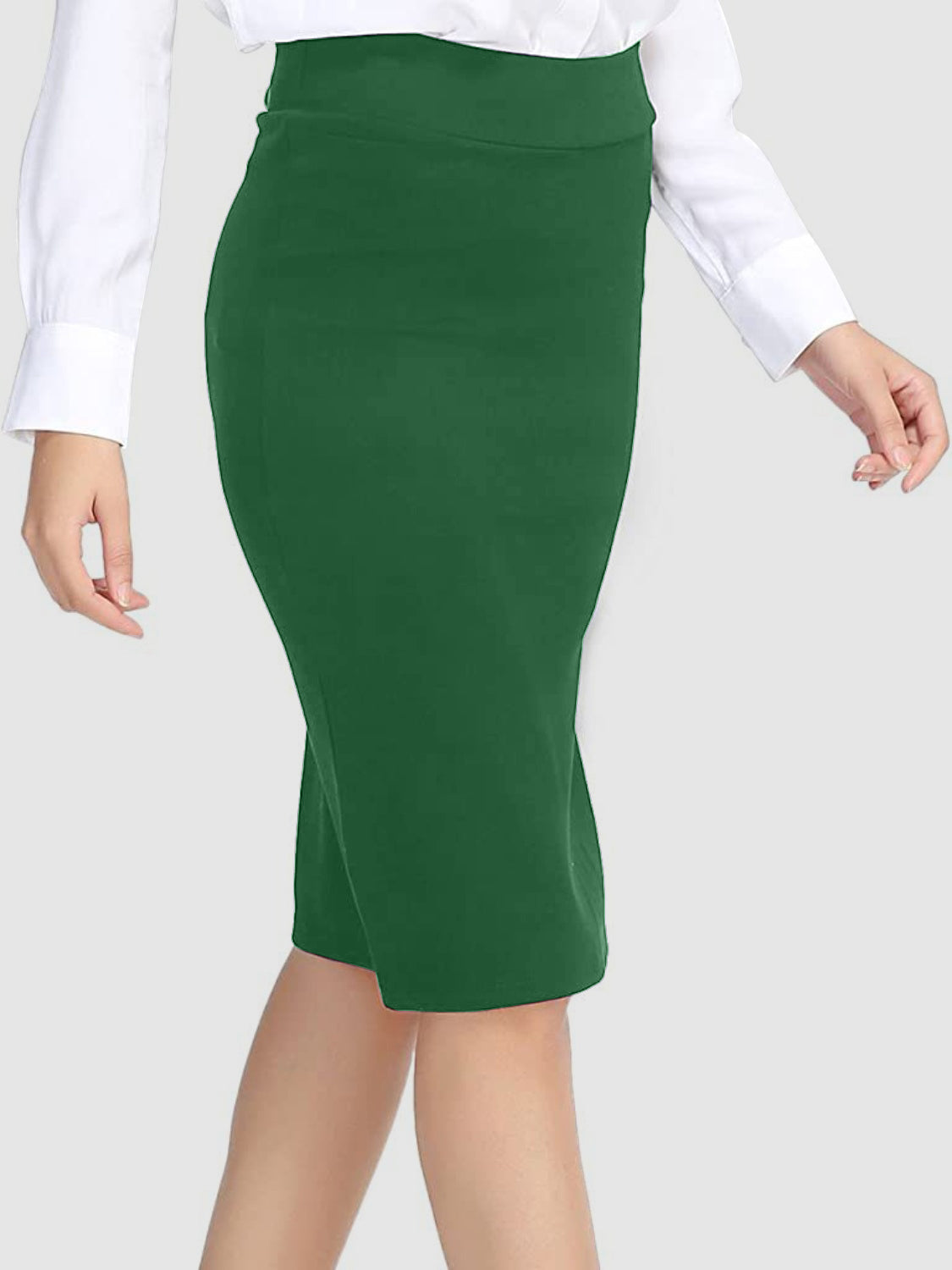 Green pencil skirt with a high waist and sculpted fit, styled with a white shirt.