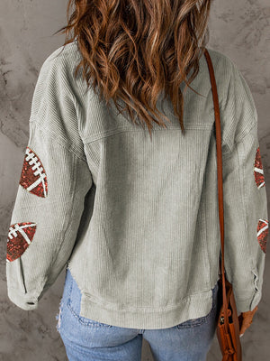 Sage corduroy overshirt with football sequin embellishments on the sleeves.