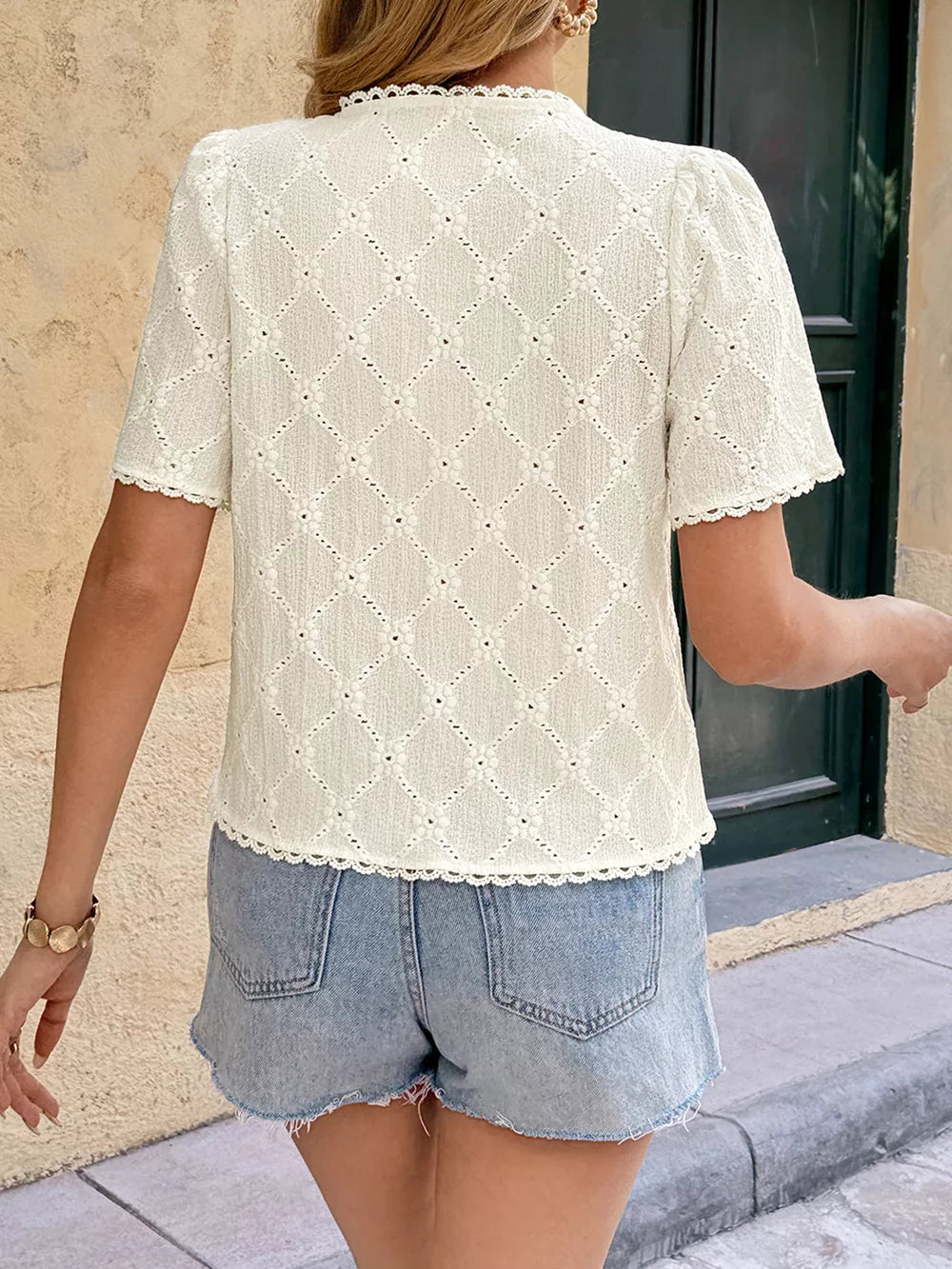 Textured knit button-up shirt with lace trim and short puff sleeves in apricot.
