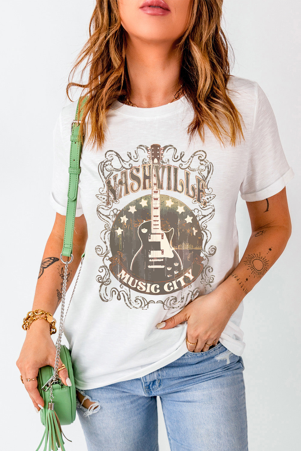 White graphic t-shirt with Nashville Music City and guitar design