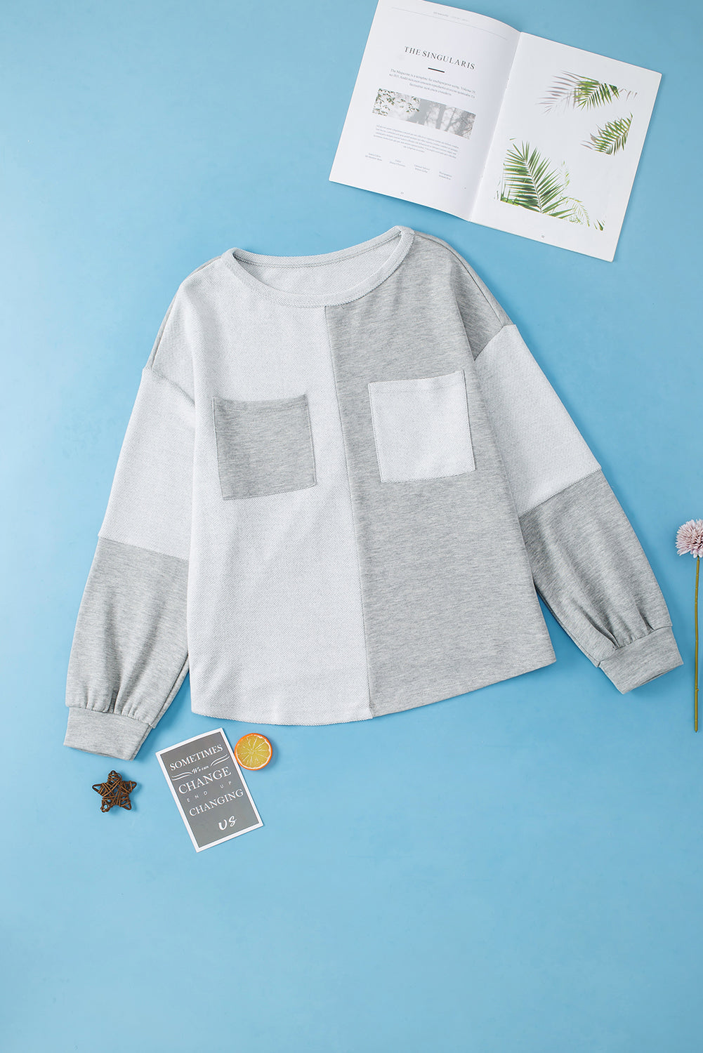 Colorblock sweatshirt in light gray with two chest pockets and slouchy sleeves.
