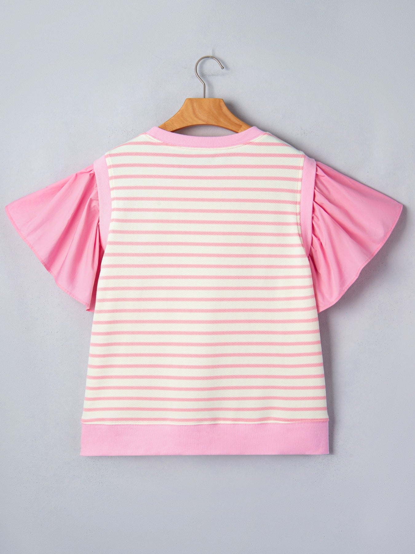 Ruffled short-sleeve blouse with pink and white stripes and solid pink sleeves.
