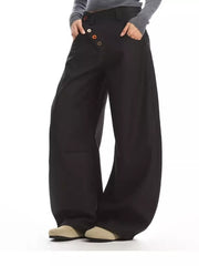Black wide-leg chinos with decorative button-fly detail and relaxed fit.