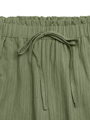 Crinkled olive green maternity pants with drawstring waist and wide legs.