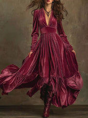 Elegant ruffled maxi dress in cerise velvet with voluminous sleeves and a deep V-neck.