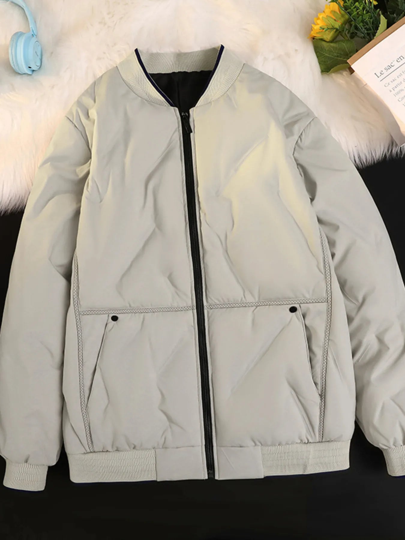 Plus-size ivory quilted bomber jacket with zip front and ribbed cuffs.