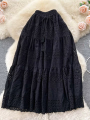 Black eyelet tiered maxi skirt with drawstring waist and tassel detail