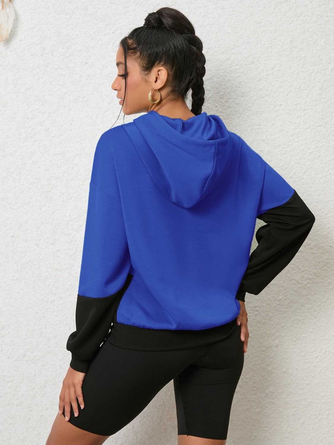 Colorblock royal blue and black hoodie with long sleeves and a hood.