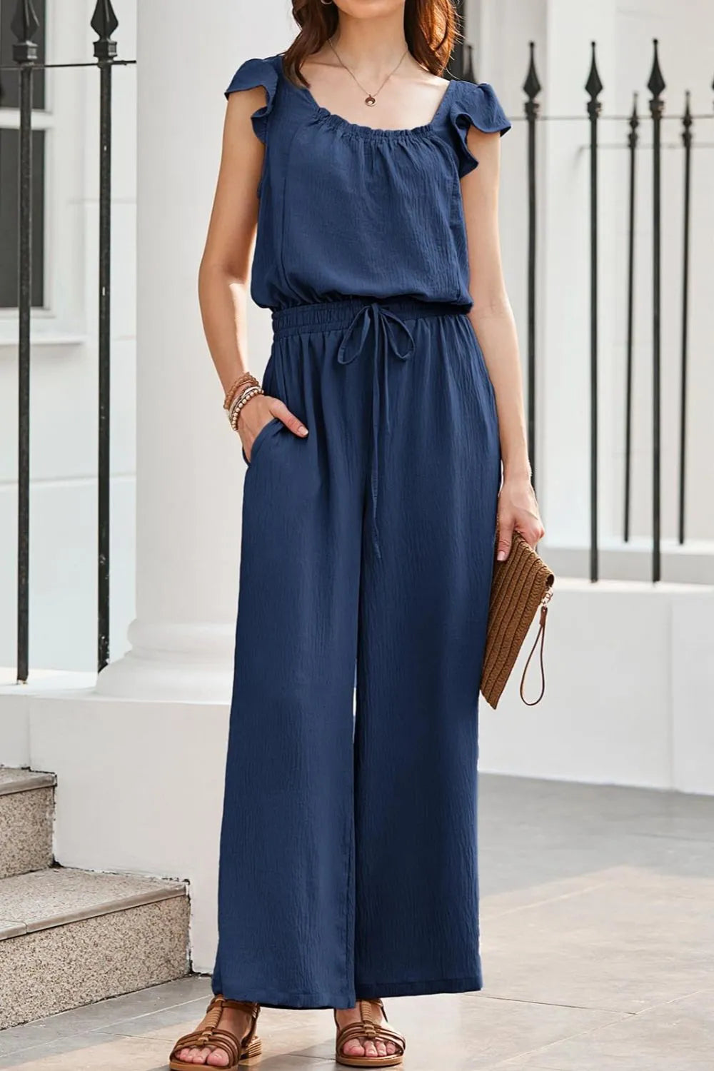Dark Blue Textured Ruffle-Sleeve Drawstring Palazzo Jumpsuit with wide legs and pockets.