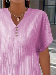 Textured light purple v-neck t-shirt with decorative buttons and short sleeves.