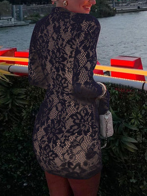 Black lace cutout mini dress with flared sleeves and a beige lining.
