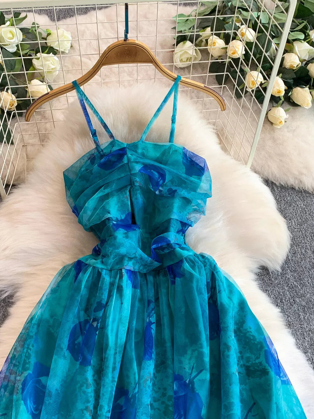 Blue floral mesh maxi dress with ruched bodice and spaghetti straps.