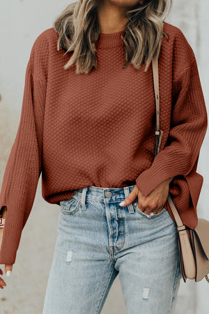 Textured sleeve slit knit sweater in ochre with crew neck and relaxed fit.