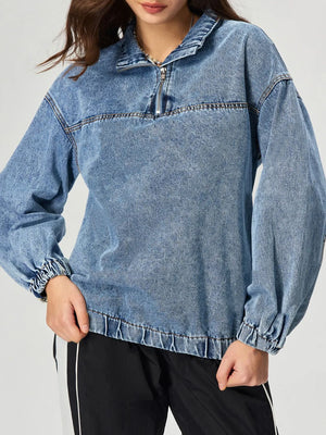 Acid wash denim pullover with quarter zip and cinched cuffs.