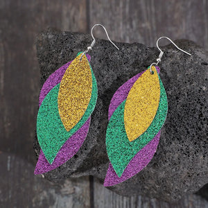 Glittering layered leaf statement earrings in gold, green, and purple.