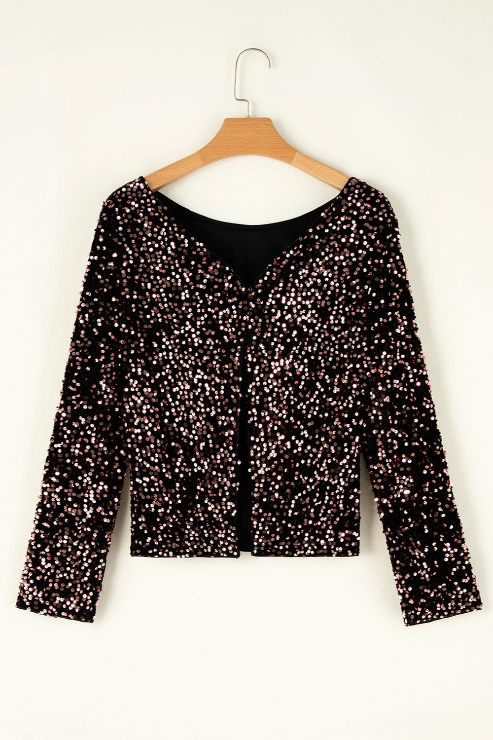 Black sequin backless blouse with long sleeves and a V-neckline.