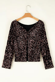 Black sequin backless blouse with long sleeves and a V-neckline.