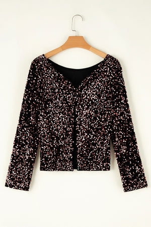 Black sequin backless blouse with long sleeves and a V-neckline.