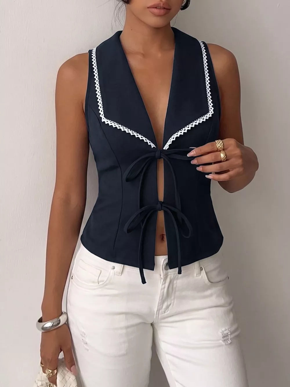 Navy lace-trimmed tie-front vest with a deep V-neckline.