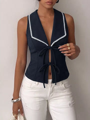 Navy lace-trimmed tie-front vest with a deep V-neckline.