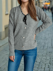 Gray knit cardigan with ribbon trim neckline, tie, and button front.