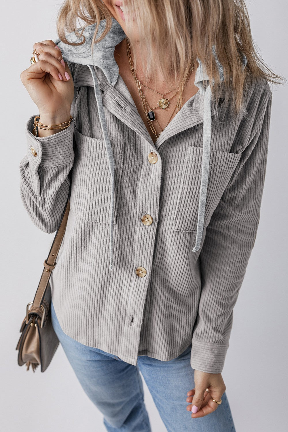 Gray corduroy shirt jacket with contrast hood, button front, chest pockets, and drawstring details.
