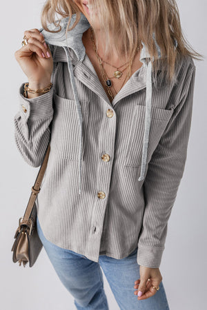 Gray corduroy shirt jacket with contrast hood, button front, chest pockets, and drawstring details.