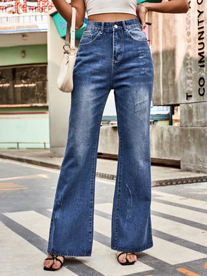 Dark blue denim flared jeans with distressed details and a high waist.